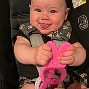 Isla joined the competition — help win amazing prizes! baby, infant, smiling, tongue_out, headband, teether, pink, car_seat, straps, floral_pattern, chubby_cheeks, cute, hands, legs, black_clothing, close_up, indoor, child, happy, playful