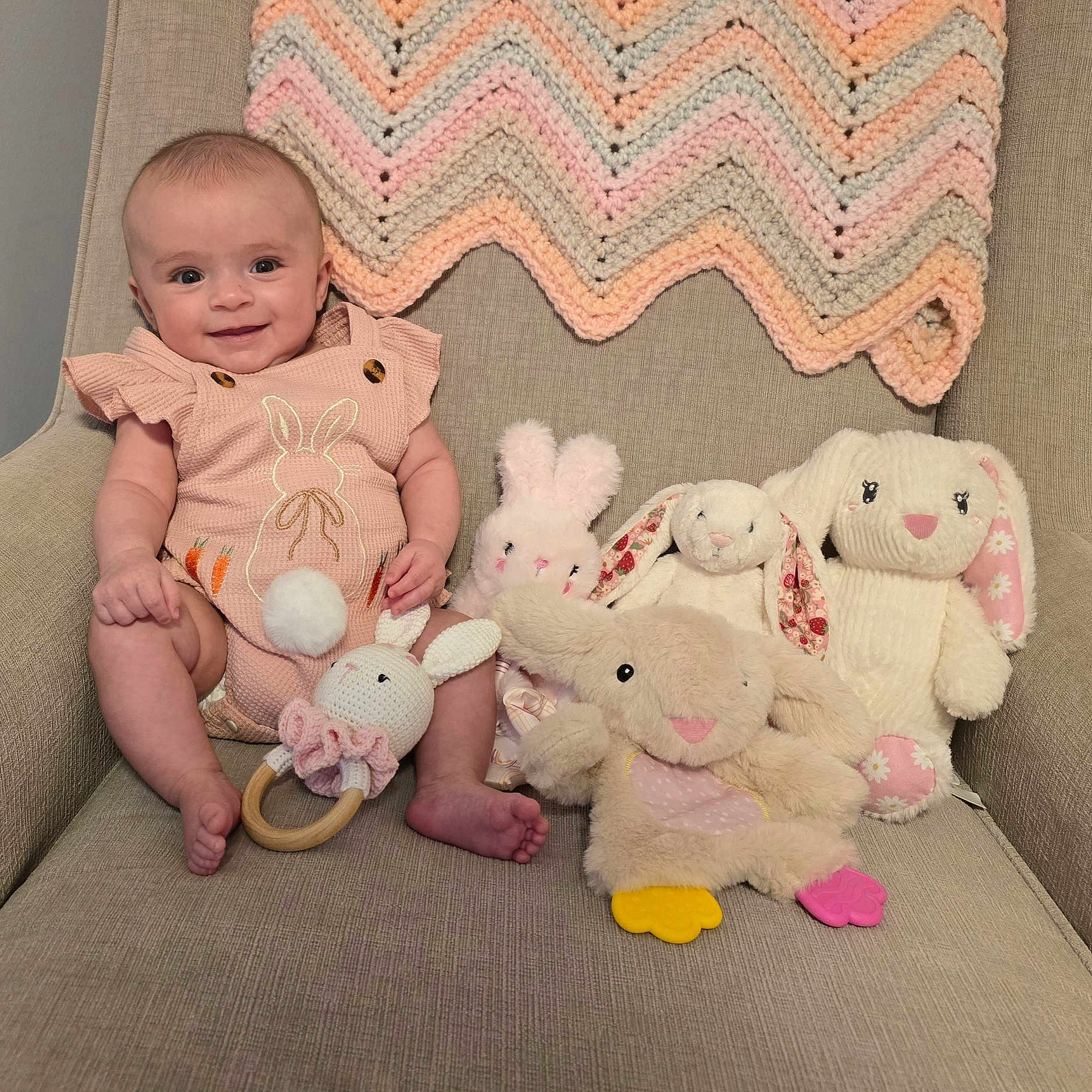 Lilian is registered to the contest to win money with this photo: baby, bed, blanket, chair, couch, cushion, face, furniture, head, homedecor, newborn, person, photography, pillow, plush, portrait, quilt, sitting, teddybear, toy