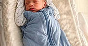 Gabriel is registered to the contest to win money with this photo: newborn, baby, sleeping, swaddled, blue_sleeping_sack, blanket, bassinet, infant, cozy, soft_lighting, portrait, cute, child, peaceful, resting, indoors, baby_clothes, love_message, text_overlay, tender_moment
