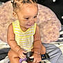 Germani joined the competition — help win amazing prizes! baby, bantu_knots, bed, child, cute, face, hair, happy, indoor, infant, pacifier, pillow, portrait, remote_control, sitting, skin, small_hand, smiling, toddler, yellow_clothing
