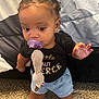 baby, black_shirt, bow, carpet, child, clothing, cute, denim_shorts, earrings, expression, face, foot, hair, hand, home, indoor, pacifier, person, standing, toddler