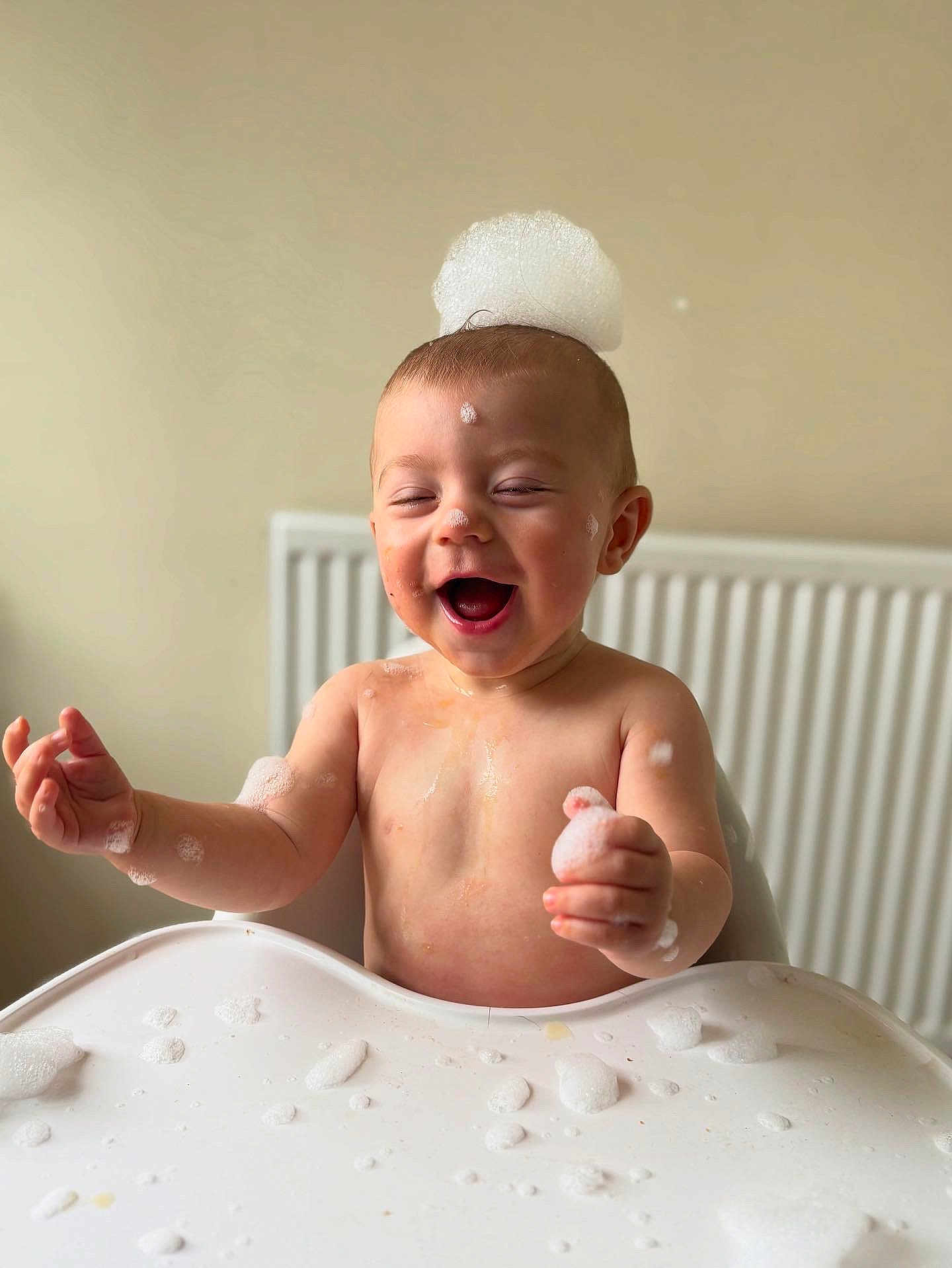 Reggie joined the competition — help win amazing prizes! baby, child, foam, bubbles, high_chair, happy, laughing, soap, skin, head, hand, table, indoor, playful, water, messy, cute, joyful, smiling, infant