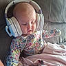 baby, infant, child, sleeping, headphones, music, portrait, floral_clothing, onesie, blanket, pink_blanket, couch, indoor, seated, face, closed_eyes, cozy, colorful, home, photography
