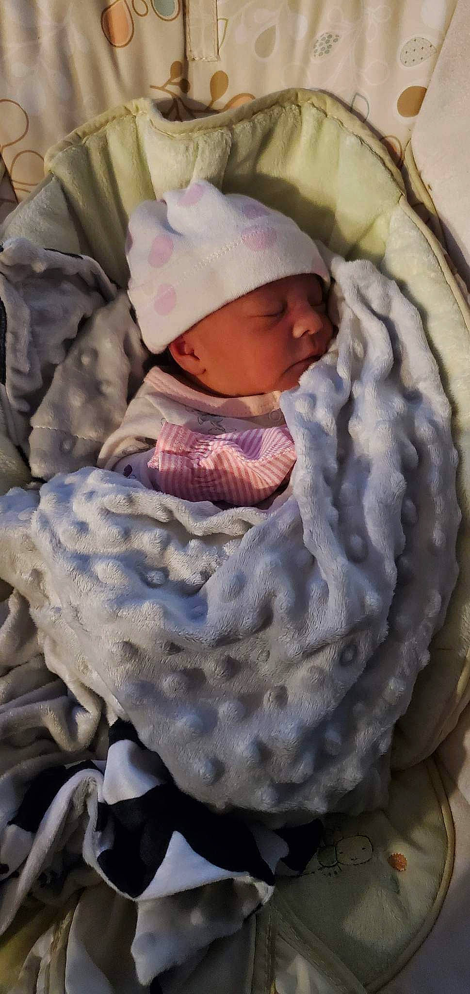 Macie is registered to the contest to win money with this photo: art, baby, baby_products, baby_toddler_clothing, child, comfort, hat, headgear, headwear, linens, military_camouflage, pattern, person, sleeve, toddler, white