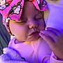 baby, sleeping, blanket, headband, pink, cartoon, face, hand, cozy, soft, infant, child, cute, closeup, indoors, purple_light, apparel, toddler, peaceful, portrait