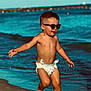 Malo a rejoint le concours — aidez-le/la à gagner de superbes lots ! child, toddler, beach, ocean, sunglasses, running, diaper, sand, sun, summer, water, barefoot, playful, happy, boy, shore, waves, portrait, outdoors, vacation