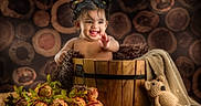 Sitara joined the competition — help win amazing prizes! baby, blanket, child, cozy, cute, decor, flowers, happy, indoor, infant, knitted_toy, natural_background, pigtails, playful, portrait, smiling, teddy_bear, warm_lighting, wood_logs, wooden_bucket