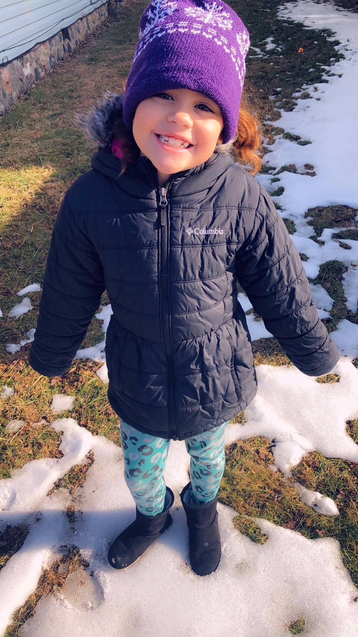 Amiyah is registered to the contest to win money with this photo: beanie, cap, child, clothing, freezing, fur, headgear, headwear, jacket, joy, knit_cap, outerwear, person, play, playing_in_the_snow, smile, snow, toddler, winter