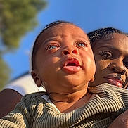 Aspen joined the competition — help win amazing prizes! baby, infant, adult, woman, face, eyes, blue_sky, outdoor, sunlight, stroller, babytrend, holding, arm, smiling, portrait, closeup, clothing, tree, skin, caregiver