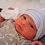 Nevaeh joined the competition — help win amazing prizes! newborn, baby, infant, hat, clothing, face, hand, eyes, blanket, soft, cute, portrait, indoors, sleepwear, resting, small, human, skin, person, newborn_clothes