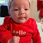 Kamelya participe au concours pour gagner de l'argent avec cette photo : baby, infant, headband, red_sweater, clothing, face, hand, indoors, portrait, cute, child, sitting, expression, skin, person, warm_clothing, home, radiator, soft_lighting, closeup