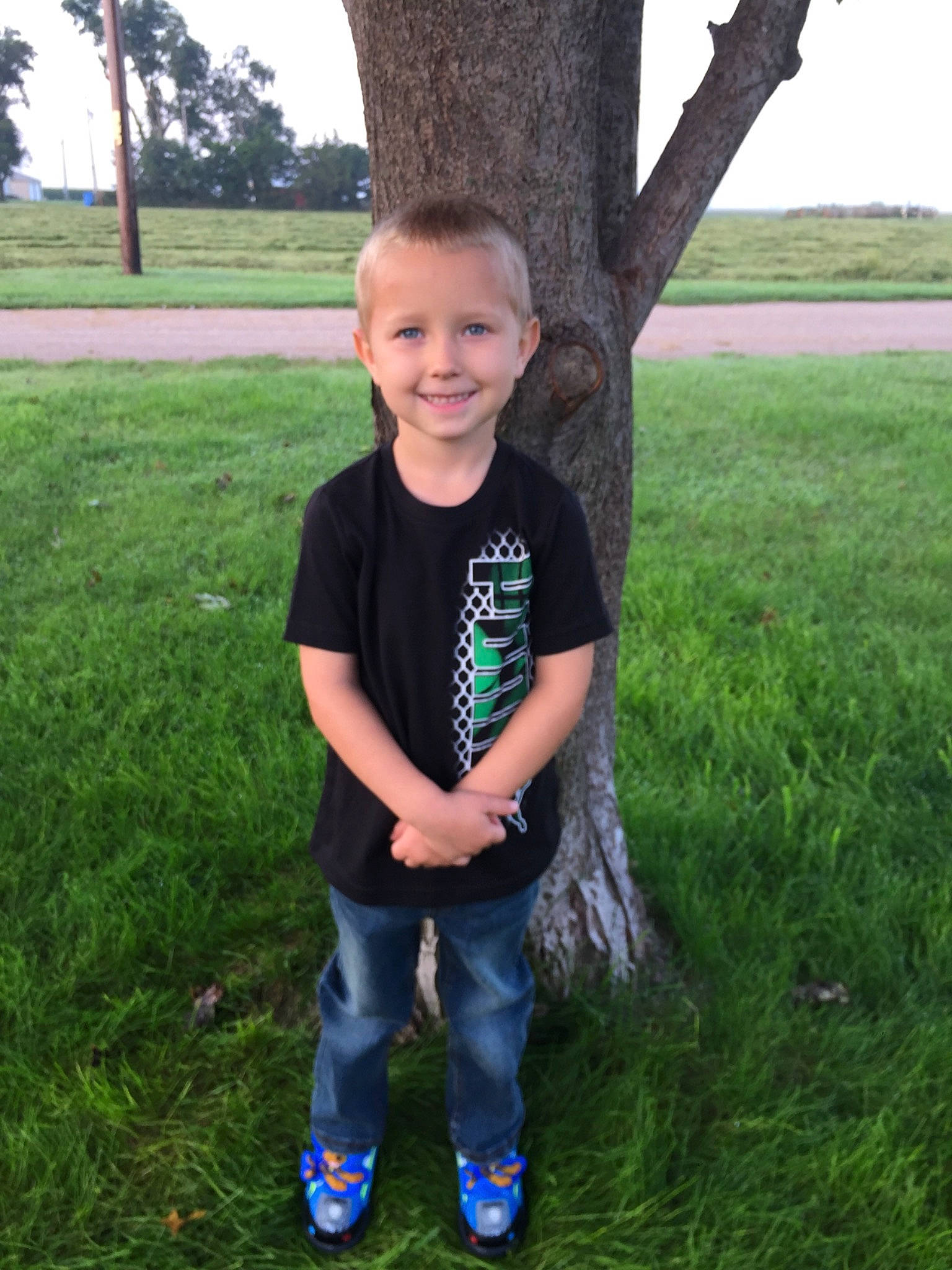 Jackson is registered to the contest to win money with this photo: child, grass, green, happy, jeans, joy, lawn, leaf, outerwear, person, plant, shoe, smile, standing, summer, t_shirt, toddler, tree, trousers