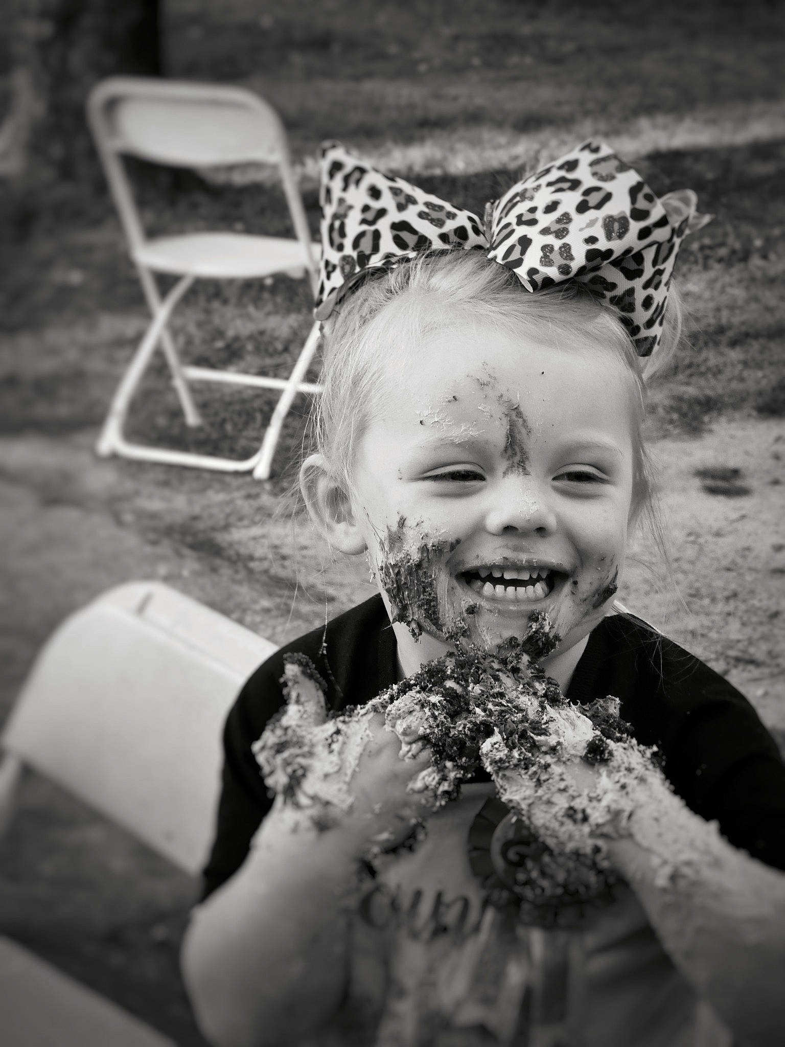 Baylee is registered to the contest to win money with this photo: black, black_and_white, chair, dress, eye, flash_photography, fun, gesture, grass, hair, hand, happy, headgear, human_body, monochrome, monochrome_photography, people_in_nature, person, smile, style