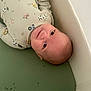 Holden joined the competition — help win amazing prizes! baby, infant, smiling, onesie, cushion, green, animal_print, vehicle_print, face, head, lying_down, comfortable, cute, child, person, indoors, soft, happy, young, skin