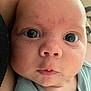 Holden is registered to the contest to win money with this photo: baby, face, close_up, infant, eyes, skin, expression, clothing, portrait, newborn, human, child, cute, looking, young, soft, person, head, mouth, nose