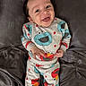 baby, child, smiling, pajamas, sesame_street, elmo, cookie_monster, lying_down, blanket, happy, cute, infant, clothing, portrait, indoors, face, person, toddler, cozy, colorful