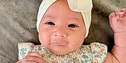 Elise is registered to the contest to win money with this photo: baby, infant, child, headband, bow, floral, clothing, blanket, cute, portrait, face, skin, hand, laying, soft, expression, young, adorable, person, indoors