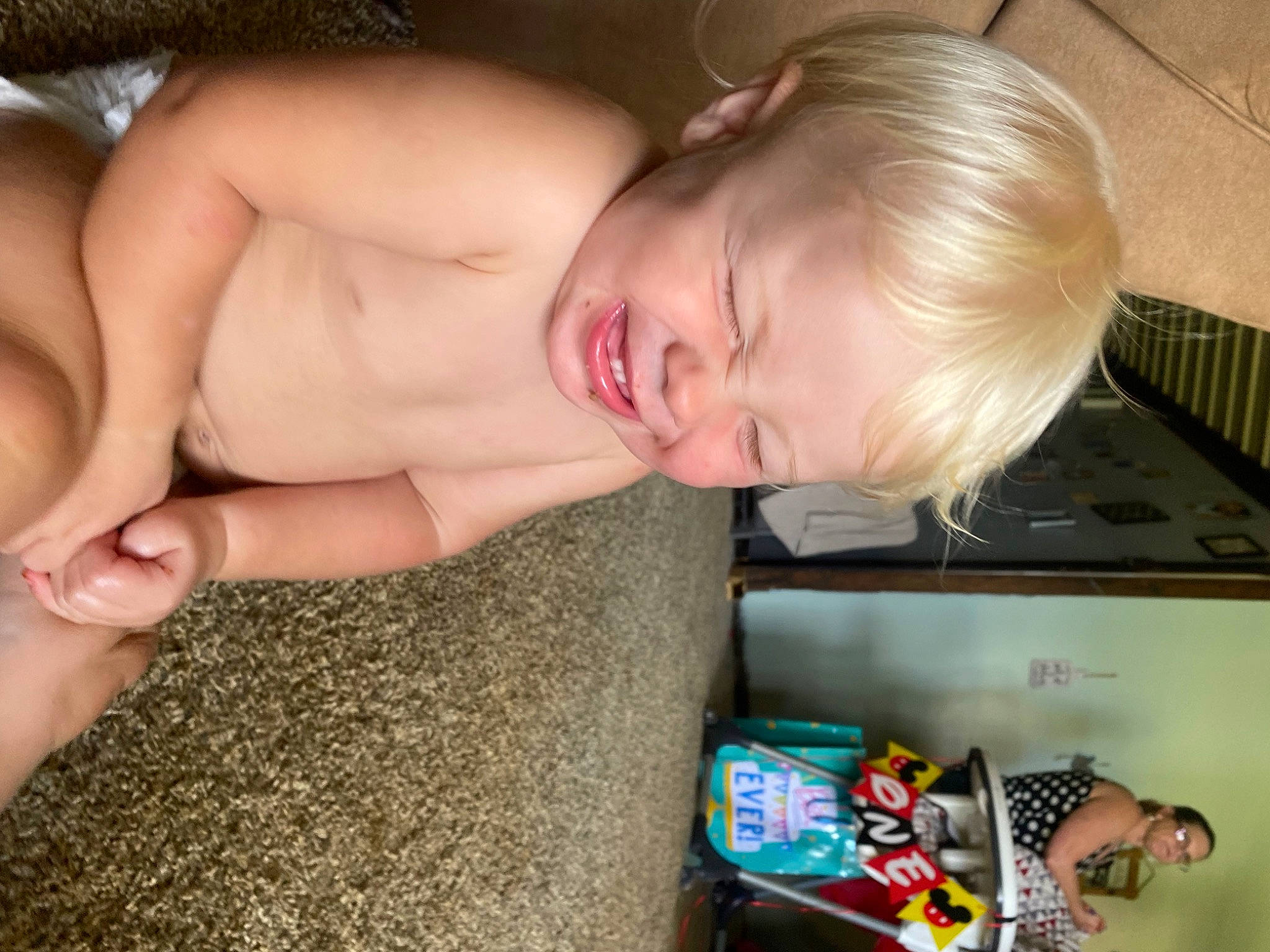 Gunnar is registered to the contest to win money with this photo: arm, baby, blond, chest, child, comfort, eye, finger, flooring, foot, fun, hand, human_leg, mouth, neck, nose, person, product, room, toddler