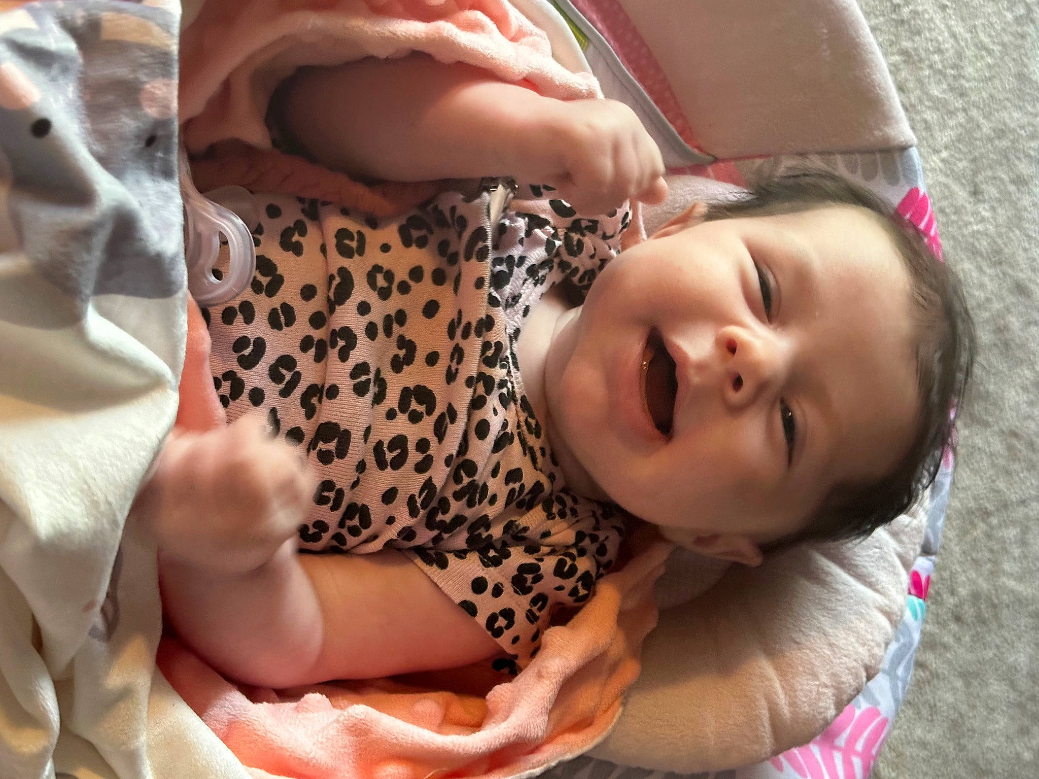 Adaline is registered to the contest to win money with this photo: baby, blond, brown_hair, cheek, child, comfort, eyelash, fun, happy, human_leg, lip, mouth, neck, pattern, person, pink, sitting, skin, smile, textile