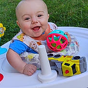 Hank joined the competition — help win amazing prizes! baby, smiling, walker, toy, ball, outdoor, grass, greenery, child, happy, playful, infant, cute, person, sitting, bright, daylight, clothing, bib, foot