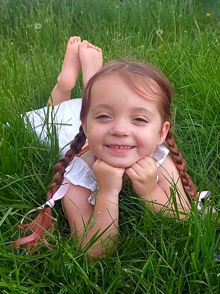 Mila is registered to the contest to win money with this photo: ecoregion, eyebrow, fawn, finger, gesture, grass, grass_family, grassland, hand, happy, human_body, iris, joy, meadow, people_in_nature, person, plant, skin, smile, thumb