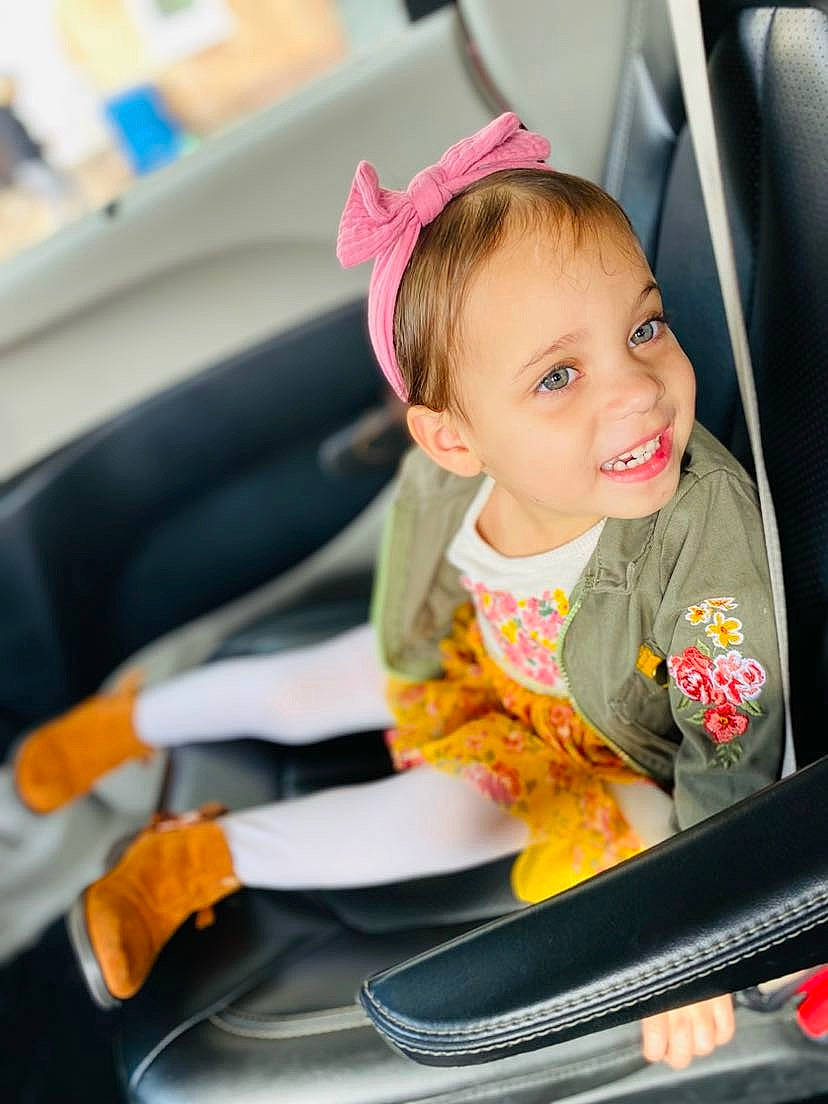 Neveah is registered to the contest to win money with this photo: auto_part, automotive_design, automotive_exterior, automotive_wheel_system, baby_carriage, baby_in_car_seat, baby_products, car, car_seat, car_seat_cover, child, happy, joy, motor_vehicle, person, seat_belt, smile, steering_part, steering_wheel, toddler