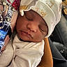 Jaziya is registered to the contest to win money with this photo: newborn, baby, sleeping, hat, white_clothing, closeup, face, infant, peaceful, soft_lighting, hand, crown_pattern, bejeweled_fabric, portrait, cute, resting, skin, cozy, indoor, person