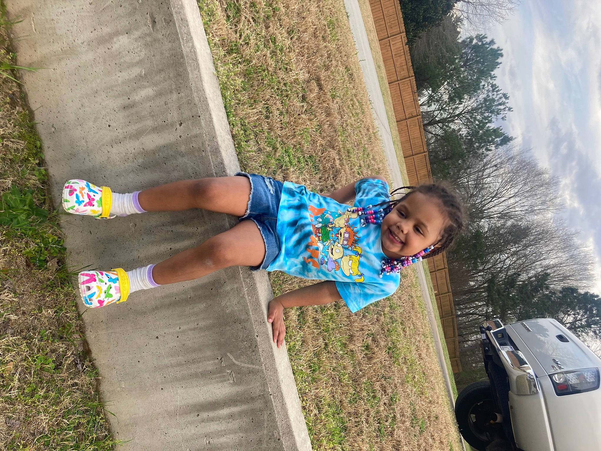 Mya is registered to the contest to win money with this photo: automotive_exterior, automotive_tire, car, electric_blue, family_car, fun, grass, happy, human_leg, joy, leisure, motor_vehicle, people_in_nature, person, plant, recreation, sky, t_shirt, thigh, toddler