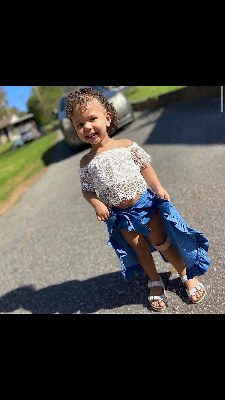 Mya is registered to the contest to win money with this photo: asphalt, child, denim, electric_blue, flash_photography, fun, gesture, grass, happy, human_leg, joy, leisure, people_in_nature, person, plant, recreation, road, sandal, sitting, smile