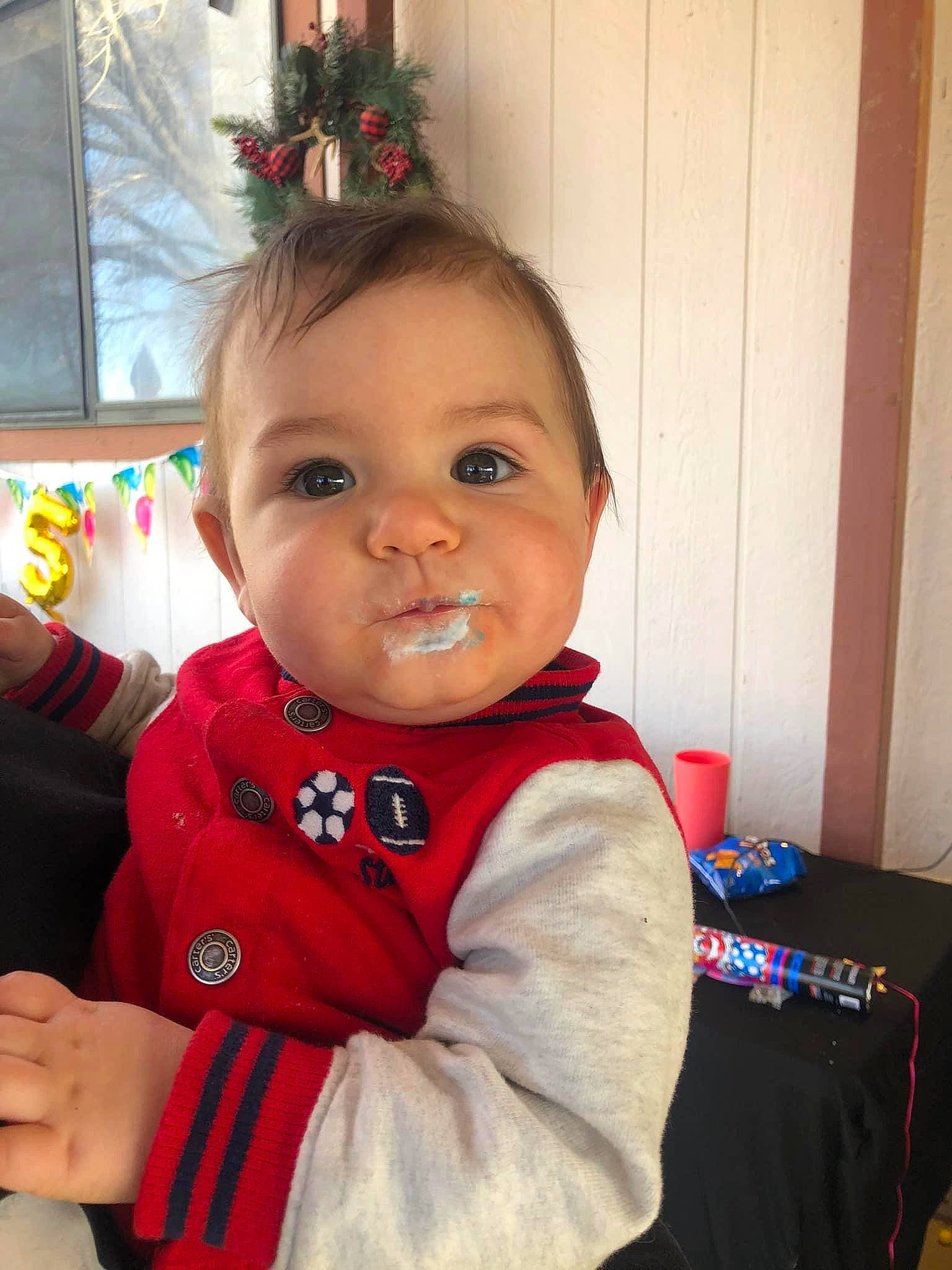 Jimmy Joe is registered to the contest to win money with this photo: baby, baby_toddler_clothing, carmine, cheek, child, christmas, christmas_ornament, door, event, eye, face, fun, happy, holiday, jacket, person, sitting, sleeve, smile, toddler