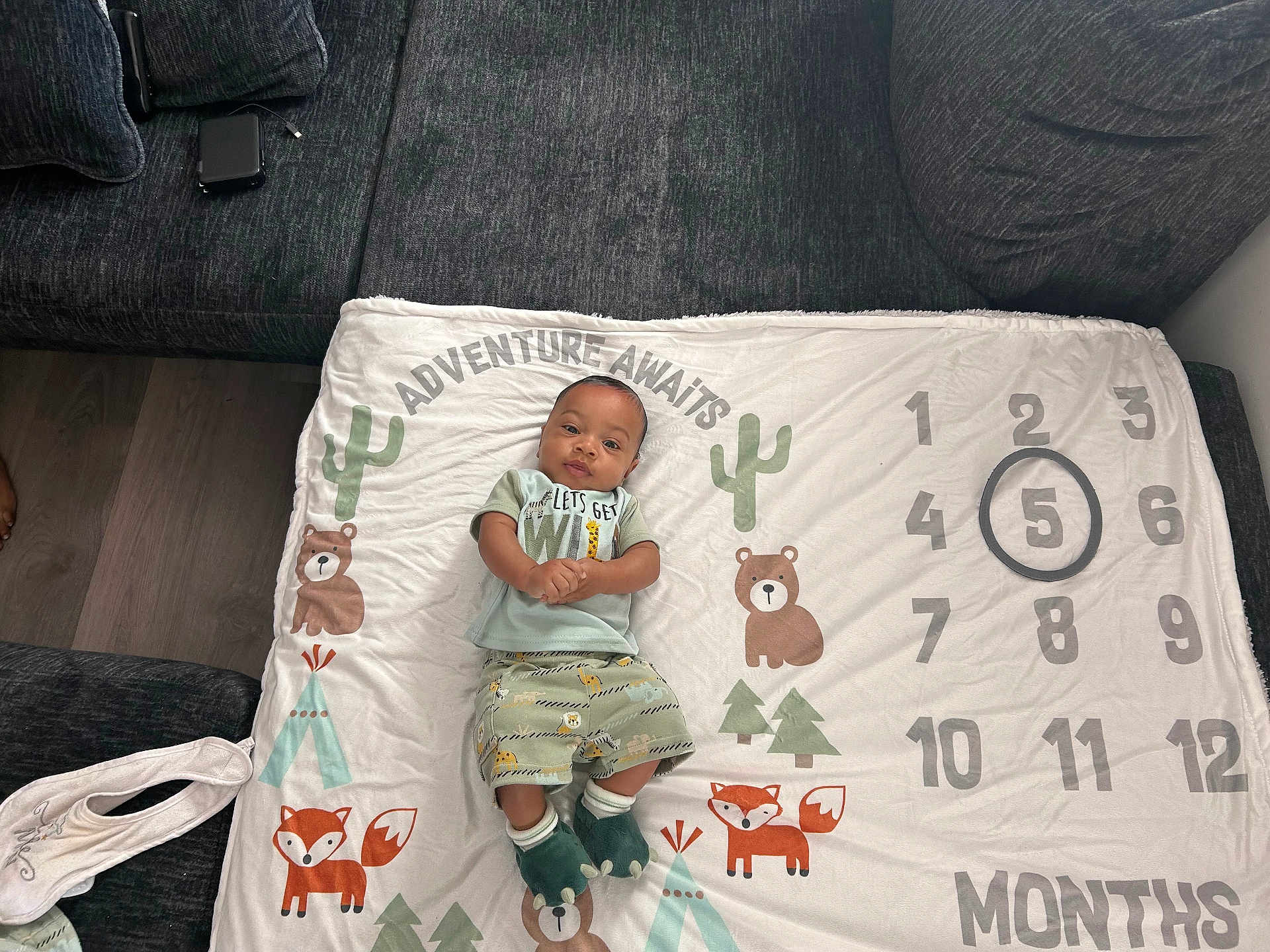 Ahmyus joined the competition — help win amazing prizes! baby, infant, blanket, milestone_blanket, numbers, circled_number, fox, bear, trees, cactus, clothing, socks, green_outfit, couch, floor, wood_floor, person, indoor, smiling, baby_bib