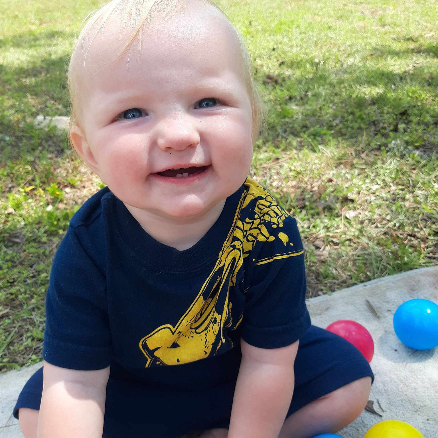Dustin joined the competition — help win amazing prizes! baby, baby_products, ball, child, face, facial_expression, fun, grass, happy, head, joy, person, play, playground, recreation, sitting, skin, smile, summer, toddler