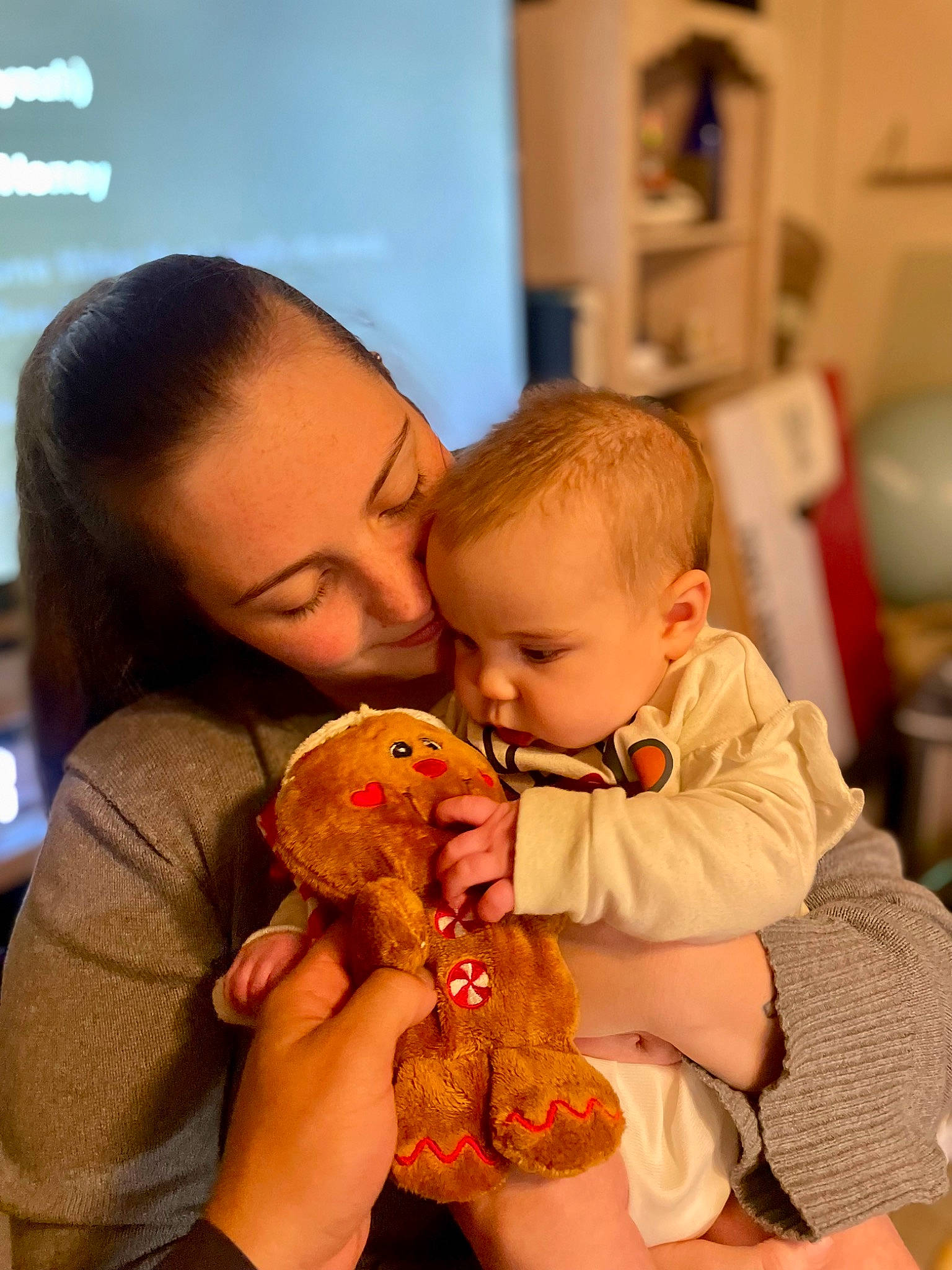 Kennedy is registered to the contest to win money with this photo: baby, baby_toddler_clothing, cheek, child, doll, event, fun, happy, holiday, mouth, nail, person, play, room, sitting, skin, stuffed_toy, sweetness, toddler, toy