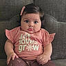 baby, infant, child, cute, pink_clothing, hair_clip, sitting, couch, gray_couch, indoor, portrait, face, eyes, hands, legs, toddler, expression, person, apparel, comfortable