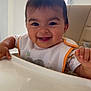 baby, smiling, high_chair, bib, indoor, child, happy, face, person, feeding, table, window, light, clothing, young_child, cute, infant, expression, sitting, home