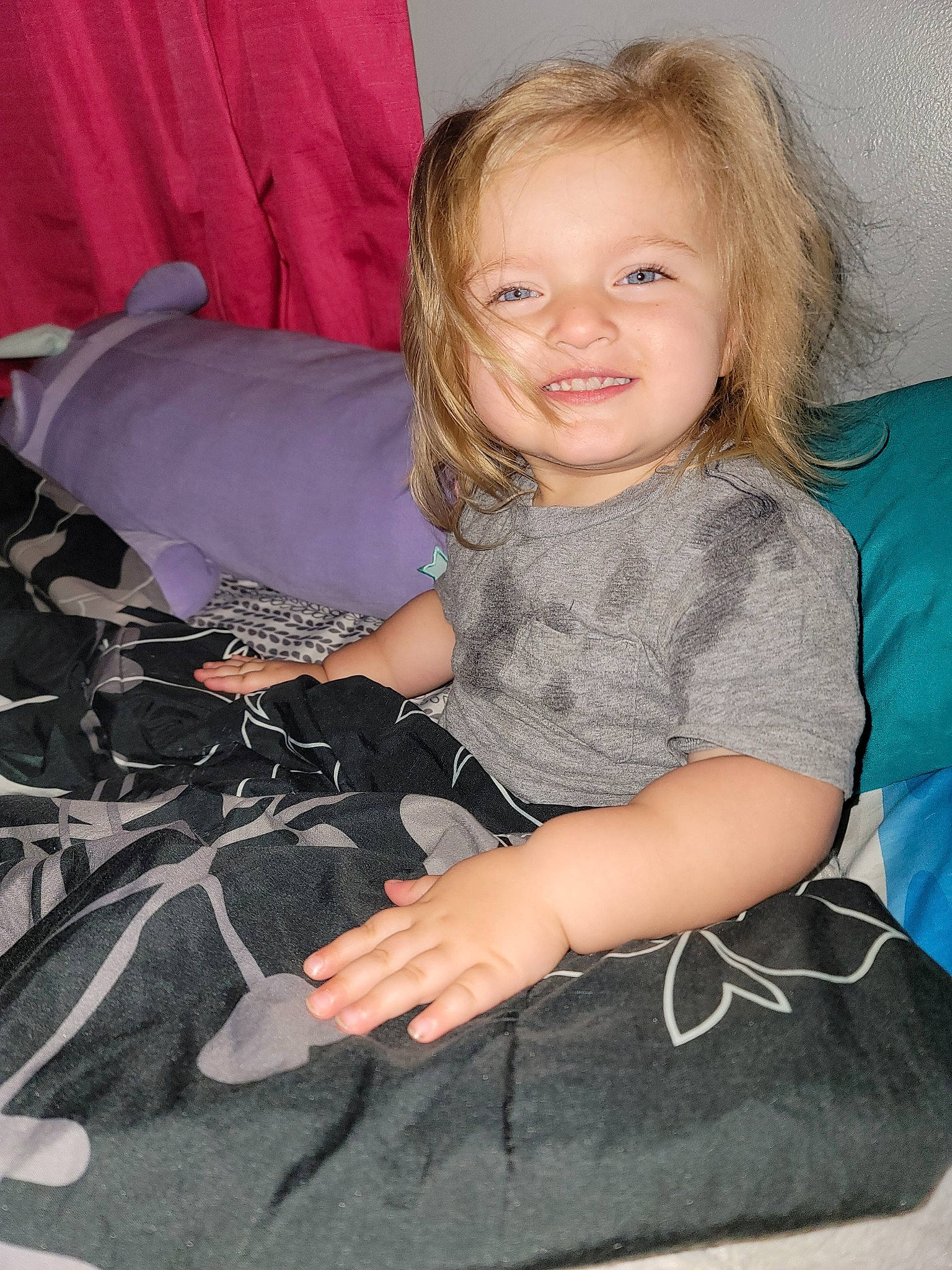 Kennedy is registered to the contest to win money with this photo: blond, comfort, couch, elbow, fun, hairstyle, happy, human_leg, joy, knee, lap, leg, long_hair, mammal, person, sitting, smile, sock, t_shirt, textile