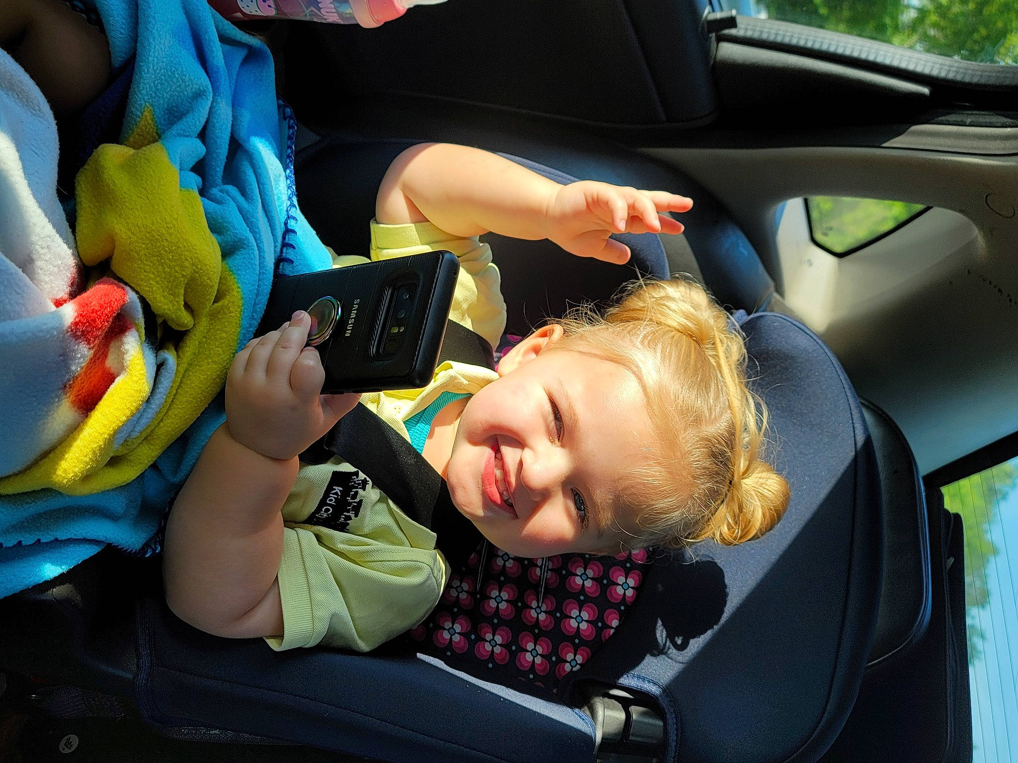 Kennedy is registered to the contest to win money with this photo: auto_part, automotive_design, automotive_exterior, car, car_seat, car_seat_cover, child, family_car, fun, head_restraint, joy, motor_vehicle, person, personal_luxury_car, seat_belt, smile, steering_wheel, toddler, travel, vehicle