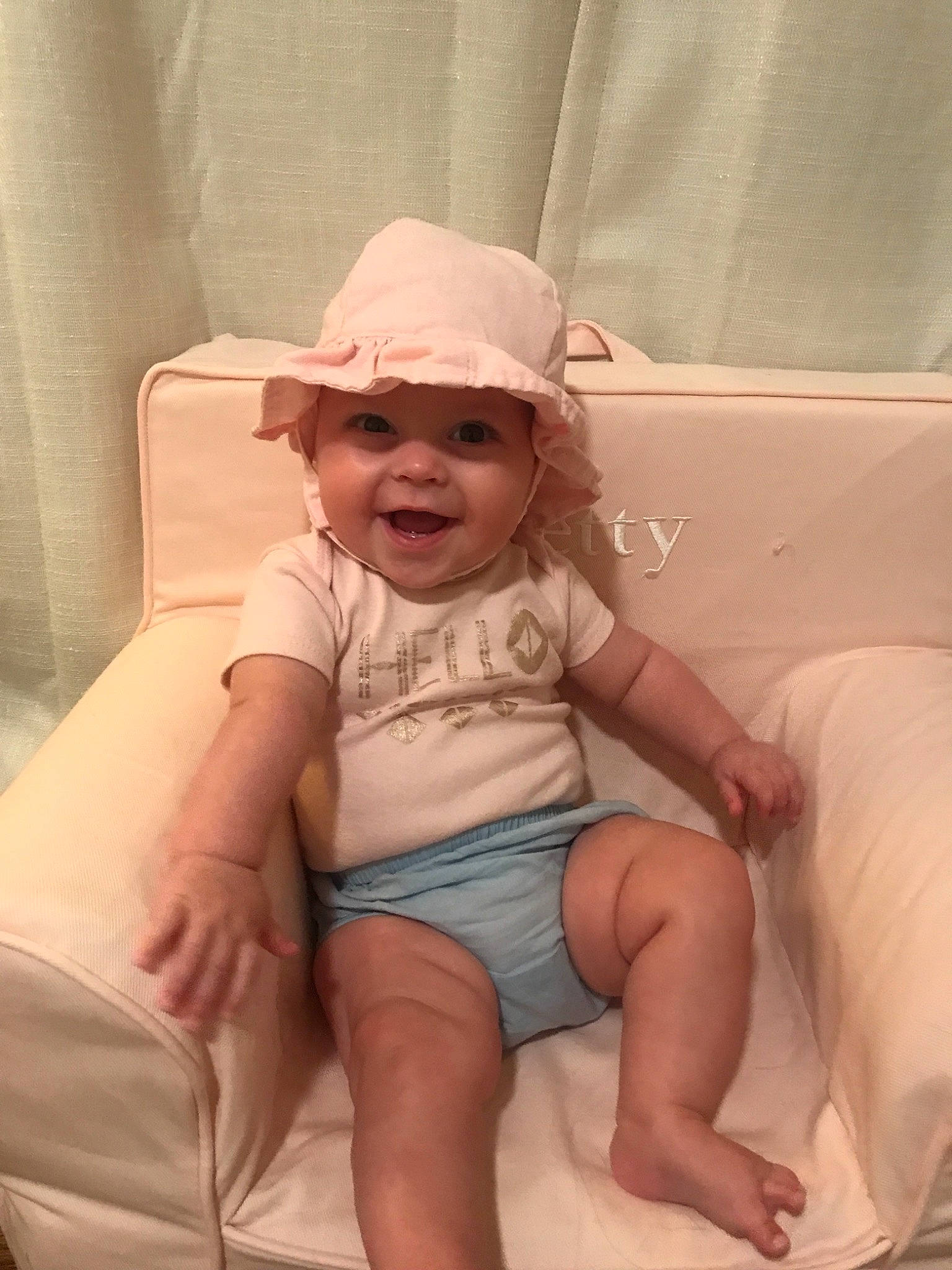 Betty is registered to the contest to win money with this photo: baby, child, hat, headgear, headwear, joy, leg, person, sitting, skin, smile, toddler