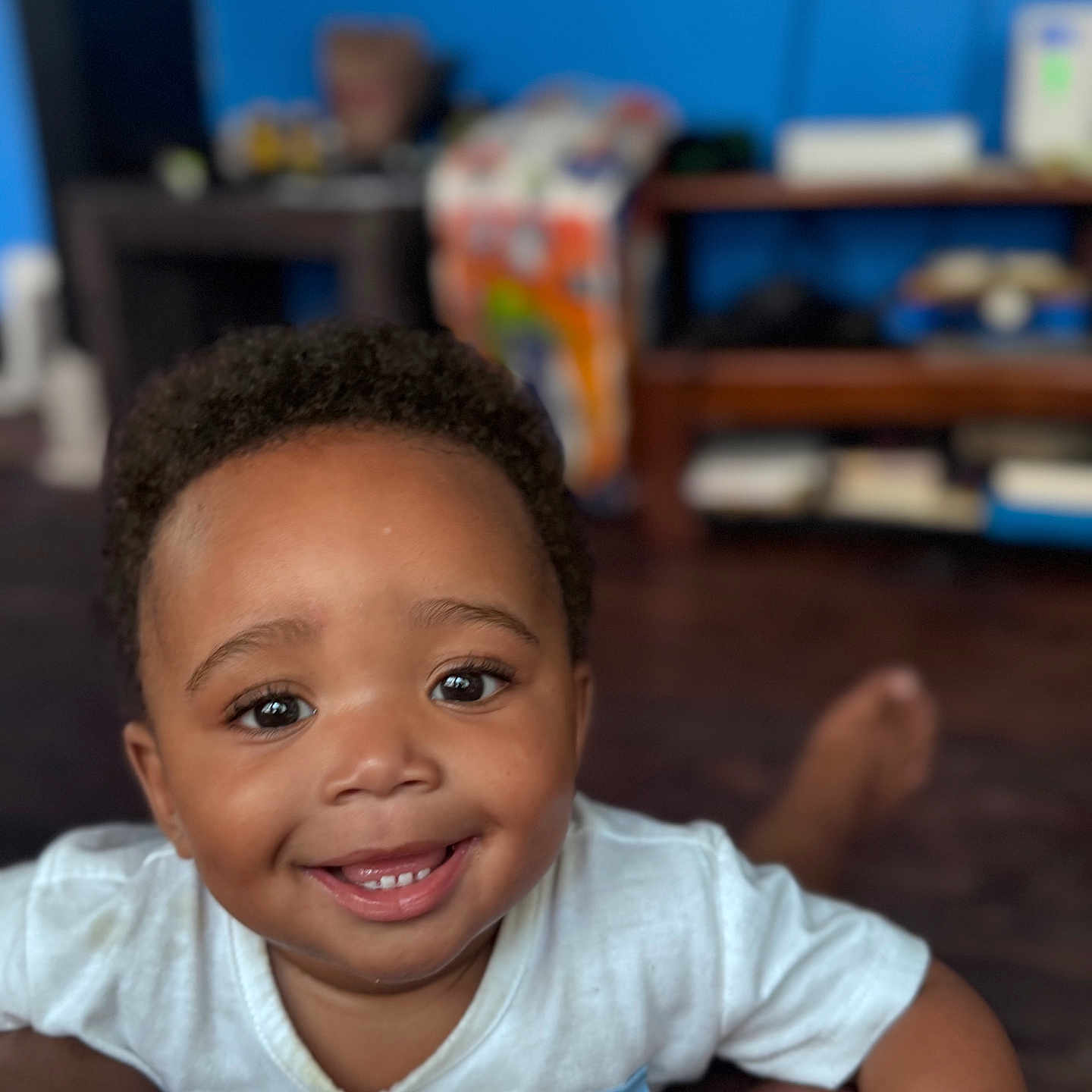 Malano joined the competition — help win amazing prizes! baby, casual_clothing, child, curly_hair, cute, expression, eyes, face, happy, home, indoor, mouth, person, playful, portrait, sitting, skin, smiling, toddler, young_child