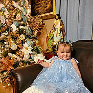 Debanhi is registered to the contest to win money with this photo: adult, architecture, baby, building, clothing, couch, dress, face, female, formalwear, furniture, head, indoors, lighting, livingroom, person, photography, portrait, room, woman