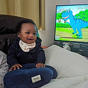 Fara is registered to the contest to win money with this photo: baby, bodypart, computerhardware, couch, cushion, electronics, face, finger, furniture, hand, hardware, head, homedecor, monitor, person, photography, portrait, screen, sitting, tv