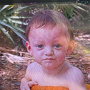 Ace is registered to the contest to win money with this photo: child, toddler, face, portrait, camera_screen, outdoor, nature, plant, leaf, soil, young_child, expression, photography, digital_display, device, hand, skin, eye_contact, head, person
