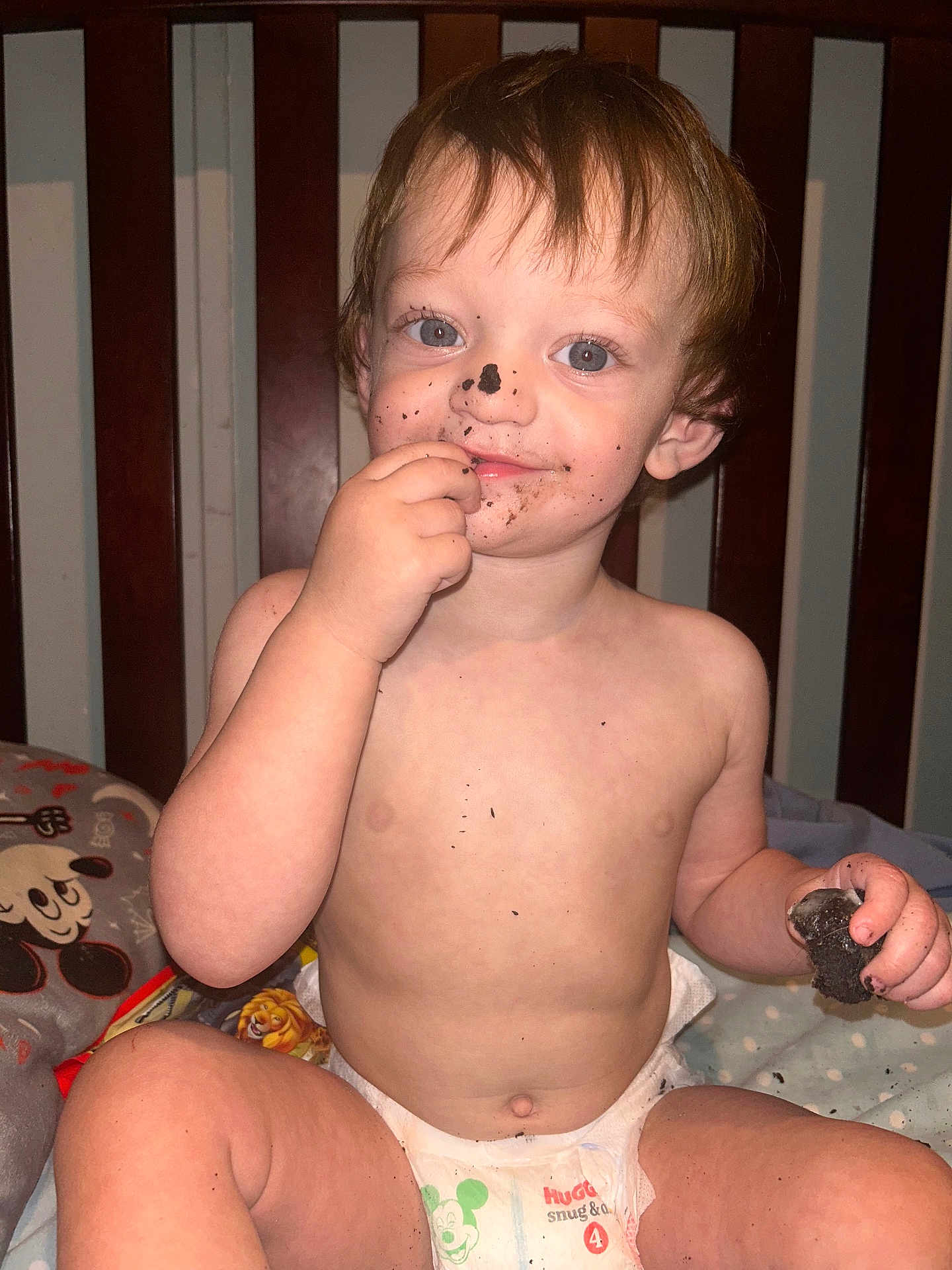Ace joined the competition — help win amazing prizes! toddler, child, diaper, chocolate, crumbs, messy, smile, face, hand, crib, bed, pillow, blanket, mickey_mouse, indoor, cute, happy, skin, hair, person