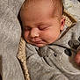 baby, sleeping, infant, face, clothing, gray, blanket, knitted, cozy, cute, bear_design, soft, peaceful, closeup, person, newborn, resting, indoors, child, portrait