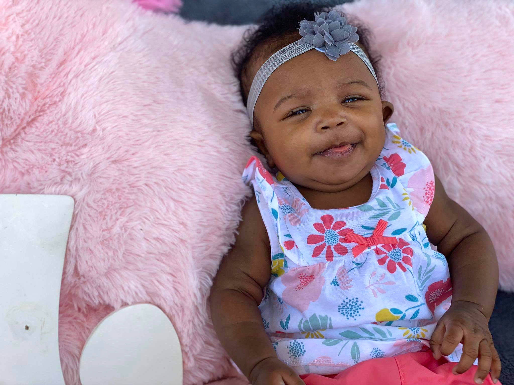 Liana is registered to the contest to win money with this photo: baby, cheek, child, ear, face, happy, head, headwear, human, neck, people, person, pink, skin, smile, toddler