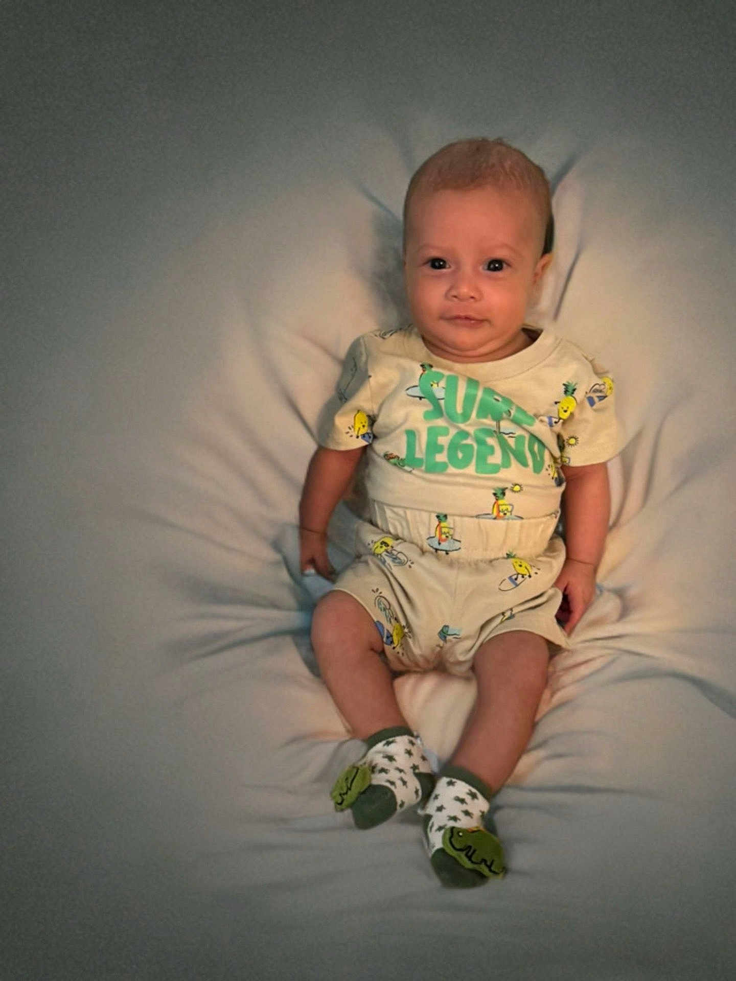 Thiago joined the competition — help win amazing prizes! baby, infant, child, sitting, clothing, socks, cute, portrait, expression, soft_surface, comfort, colorful, print, casual, indoor, person, young, head, face, looking