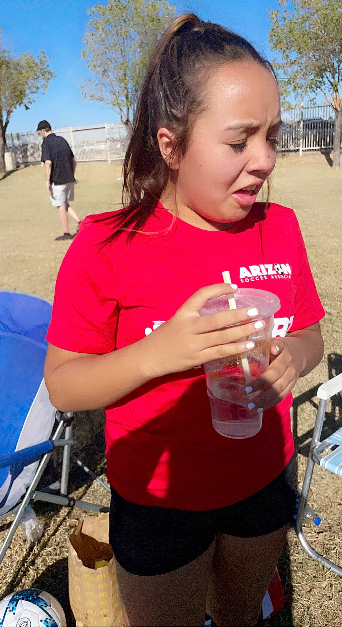 Savannah is registered to the contest to win money with this photo: blue, chair, drink, drinking, drinkware, fun, grass, happy, joint, leisure, mouth, person, pink, recreation, shorts, skin, sky, style, t_shirt, tree