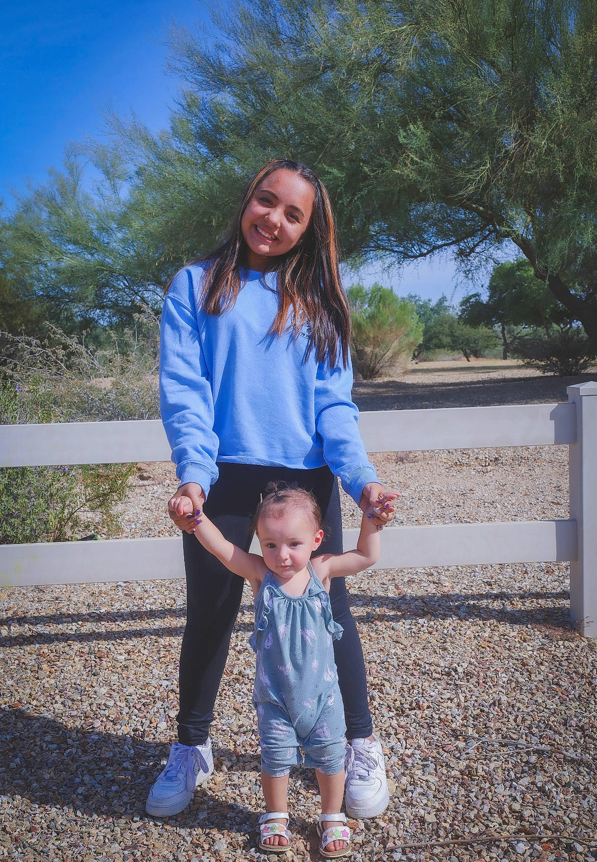 Savannah joined the competition — help win amazing prizes! clothing, denim, fence, gesture, happy, jeans, joy, leg, leisure, people_in_nature, person, shoe, sky, sleeve, smile, sneakers, standing, street_fashion, toddler, travel