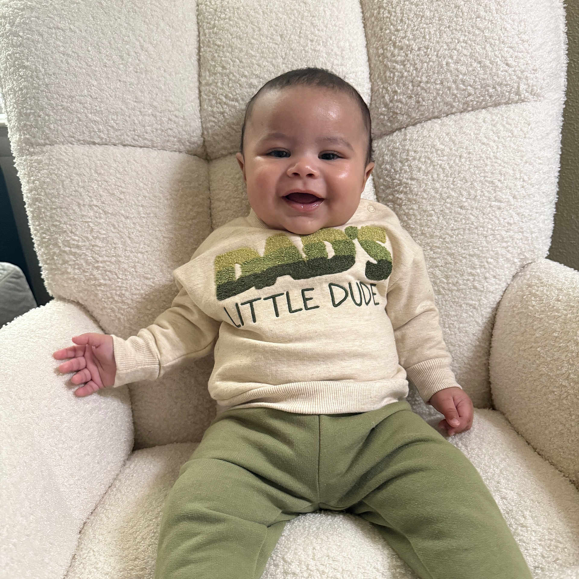 D'Markus joined the competition — help win amazing prizes! baby, child, smiling, sitting, armchair, clothing, sweater, pants, indoor, happy, face, person, furniture, cozy, cute, relaxed, infant, home, portrait, comfort