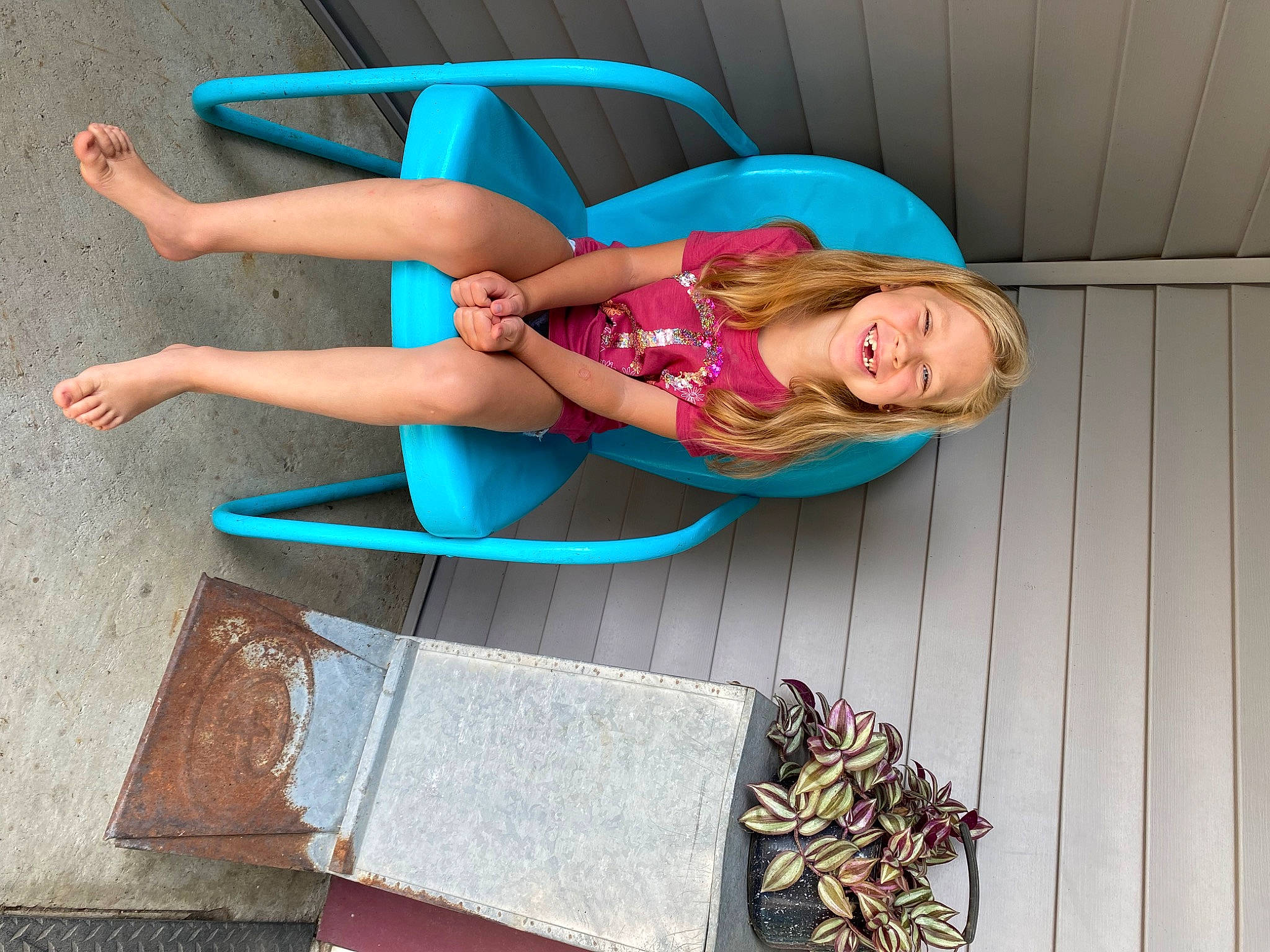 Maci is registered to the contest to win money with this photo: calf, dress, electric_blue, eyewear, foot, fun, happy, human_leg, joy, knee, leg, leisure, magenta, person, pink, red, sandal, sitting, snapshot, sportswear